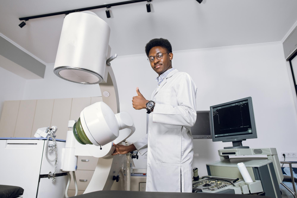 portrait-handsome-young-professional-african-man-doctor-standing-near-modern-ultrasound-lithotripter-machines-showing-thumb-up-safety-noninvasive-stone-treatment-shock-wave-lithotripsy.jpg