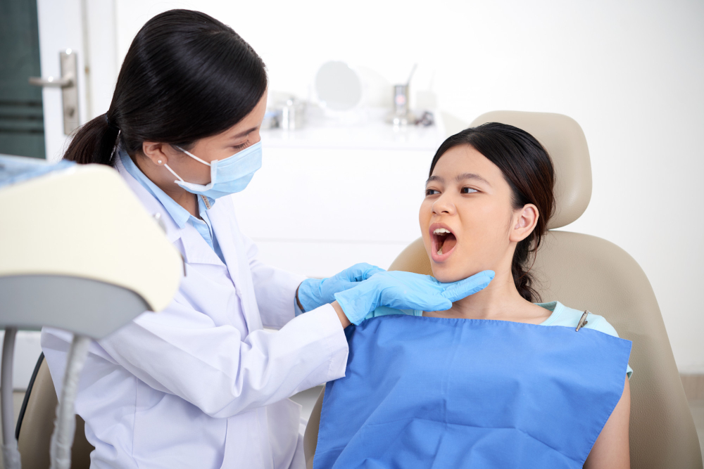 asian-female-patient-sitting-chair-with-open-mouth-dentist-looking-her-teeth.jpg